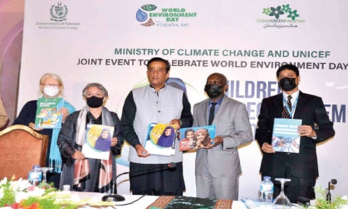 Special Assistant to the Prime Minister on Climate Change Malik Amin Aslam holds a report on the impact of climate change on chi