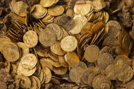 A scuba diver holds some of the gold coins recently found on the seabed in the ancient harbour in the Israeli town of Caesarea. 