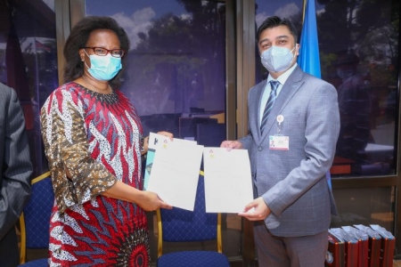 s. Susan Mochache, Principal Secretary in the Ministry of Health receives a donation of over 20,000 Covid-19 testing kits from M