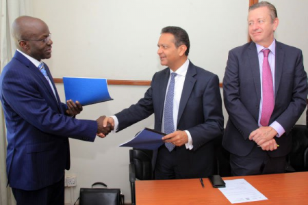 The Permanent Secretary of Ministry of Education and Sports, Mr Alex Kakooza (left), exchanges booklets with the AKDN Amin Mawji