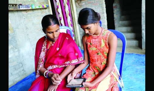 Runa and her daughter working on a tablet.