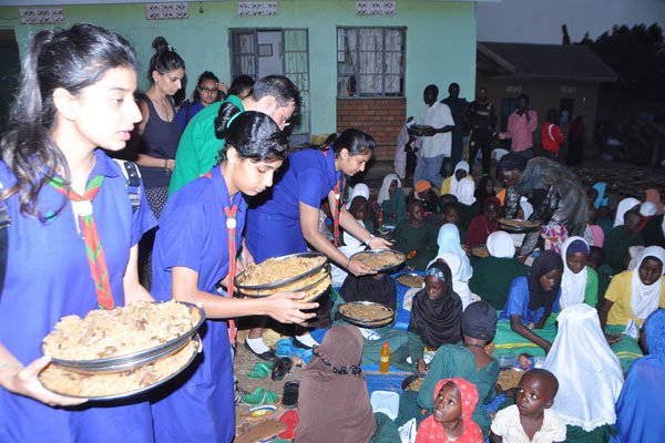 Humanitarian aid. Volunteers from the Shia Imami Ismaili Muslims, also known as the Ismailis, distributing food to orphans at th