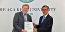 Ambassador Cerjat receives a copy of 'The Economic Impact of the Aga Khan University in Pakistan' from AKU President Dr Sulaiman